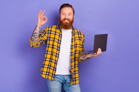 ©shutterstock Mann mit Laptop in der Hand. Mit der anderen Hand zeigt er "sehr gut"